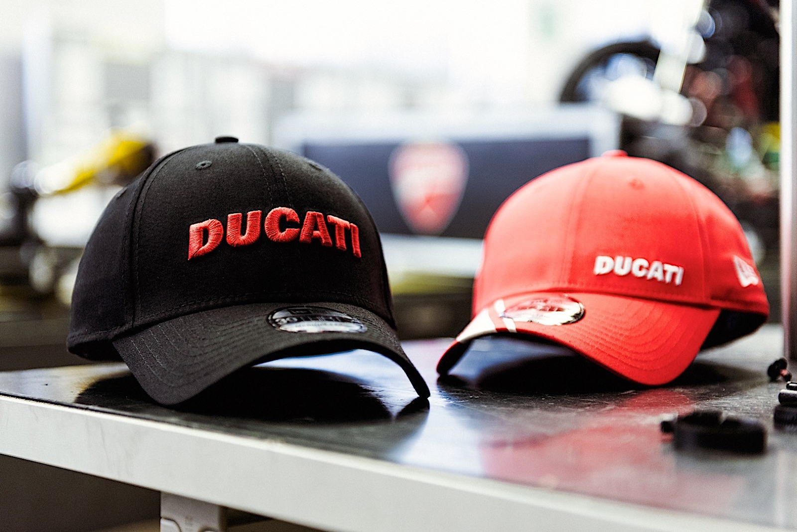 Black and red Ducati brand cap on the table