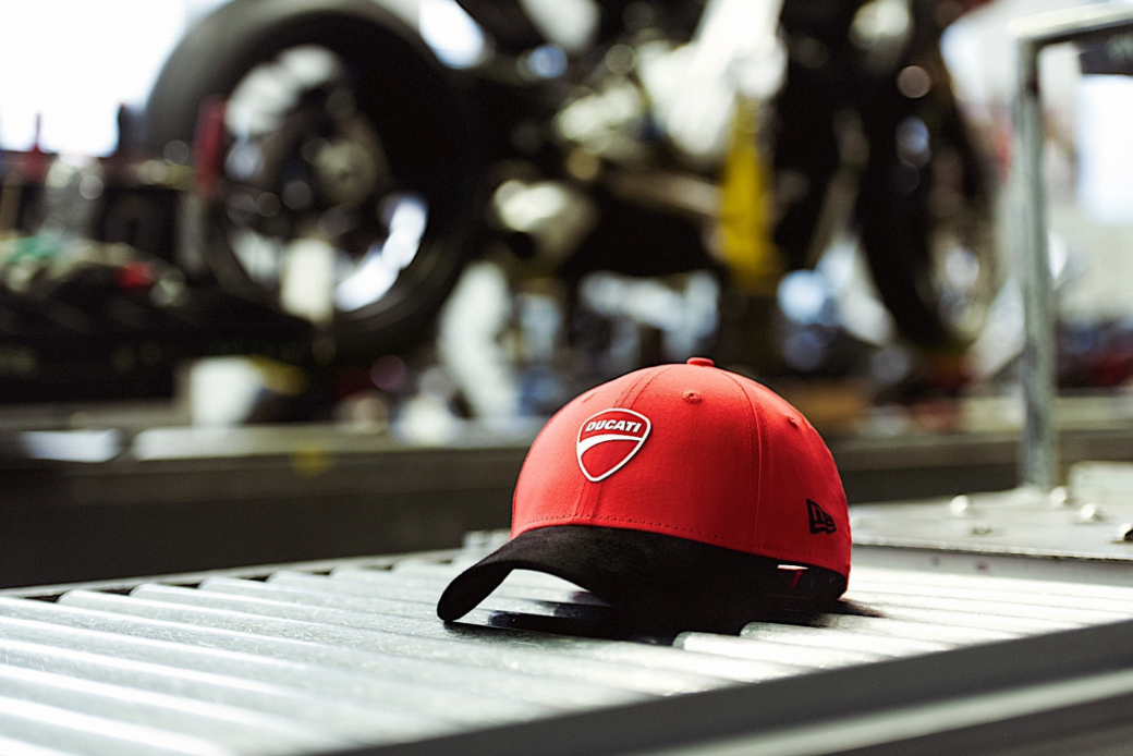 Red Ducati brand cap on the background of a motorcycle
