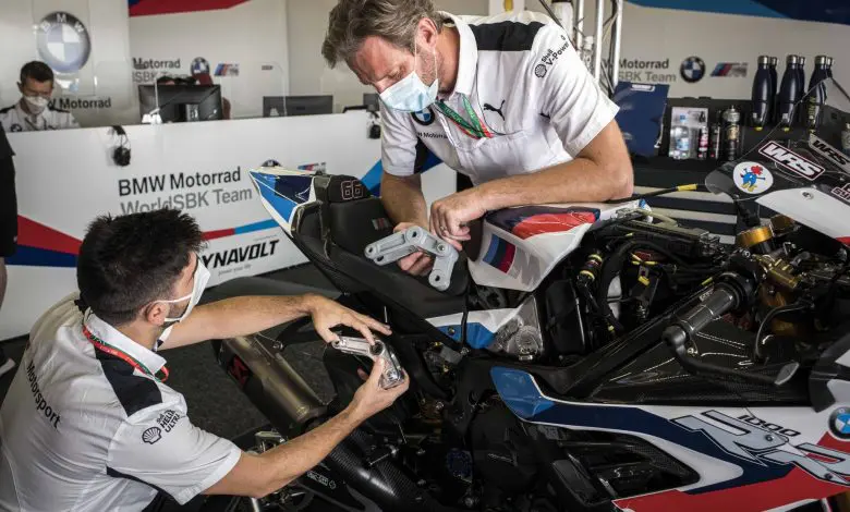 Engineers assemble a motorcycle