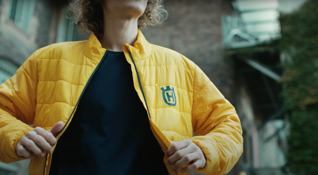 Young guy in a yellow husqvarna jacket